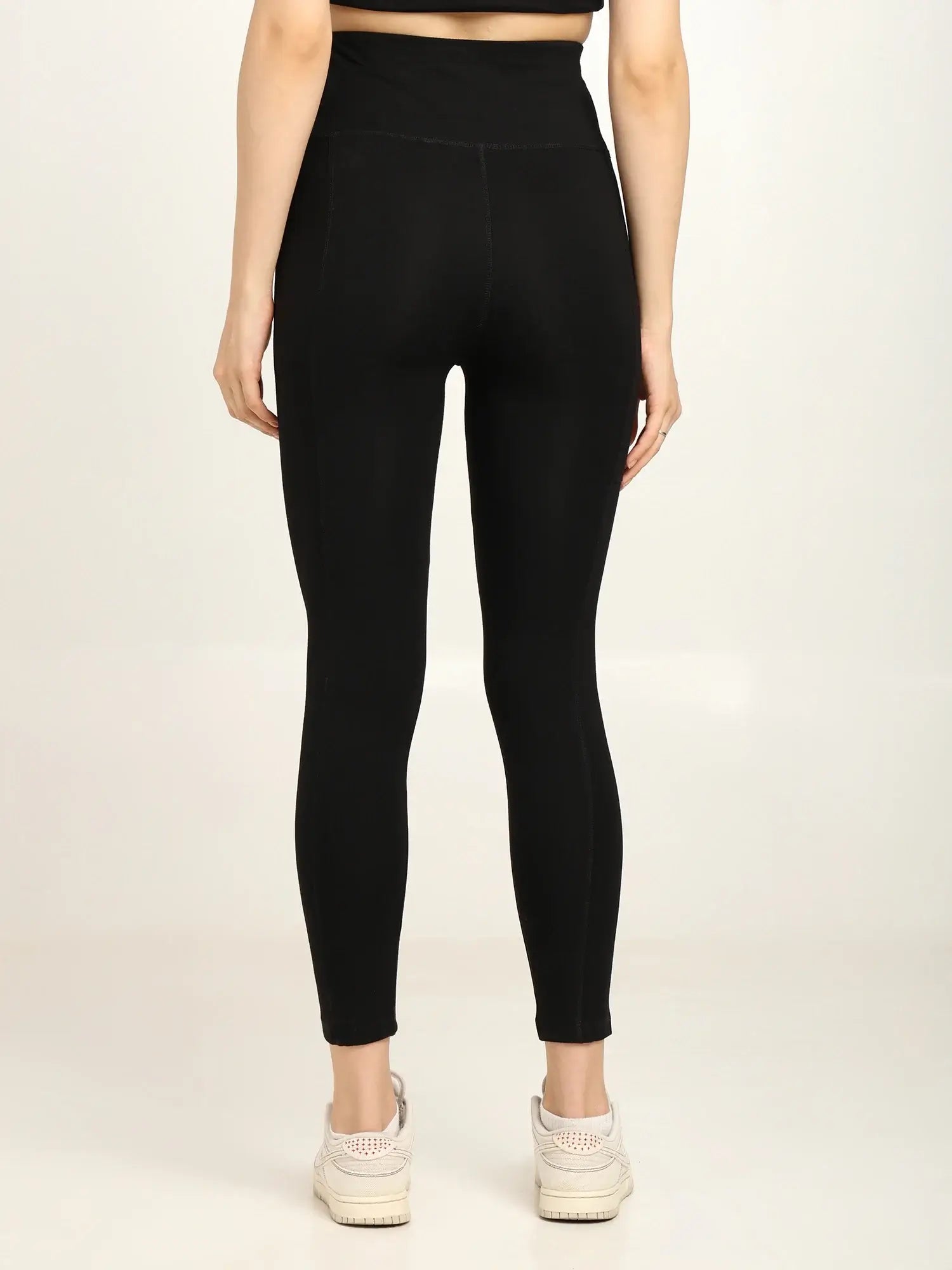 Back view of women's high-waist bamboo yoga pants in black, showcasing the soft fabric and sleek design.