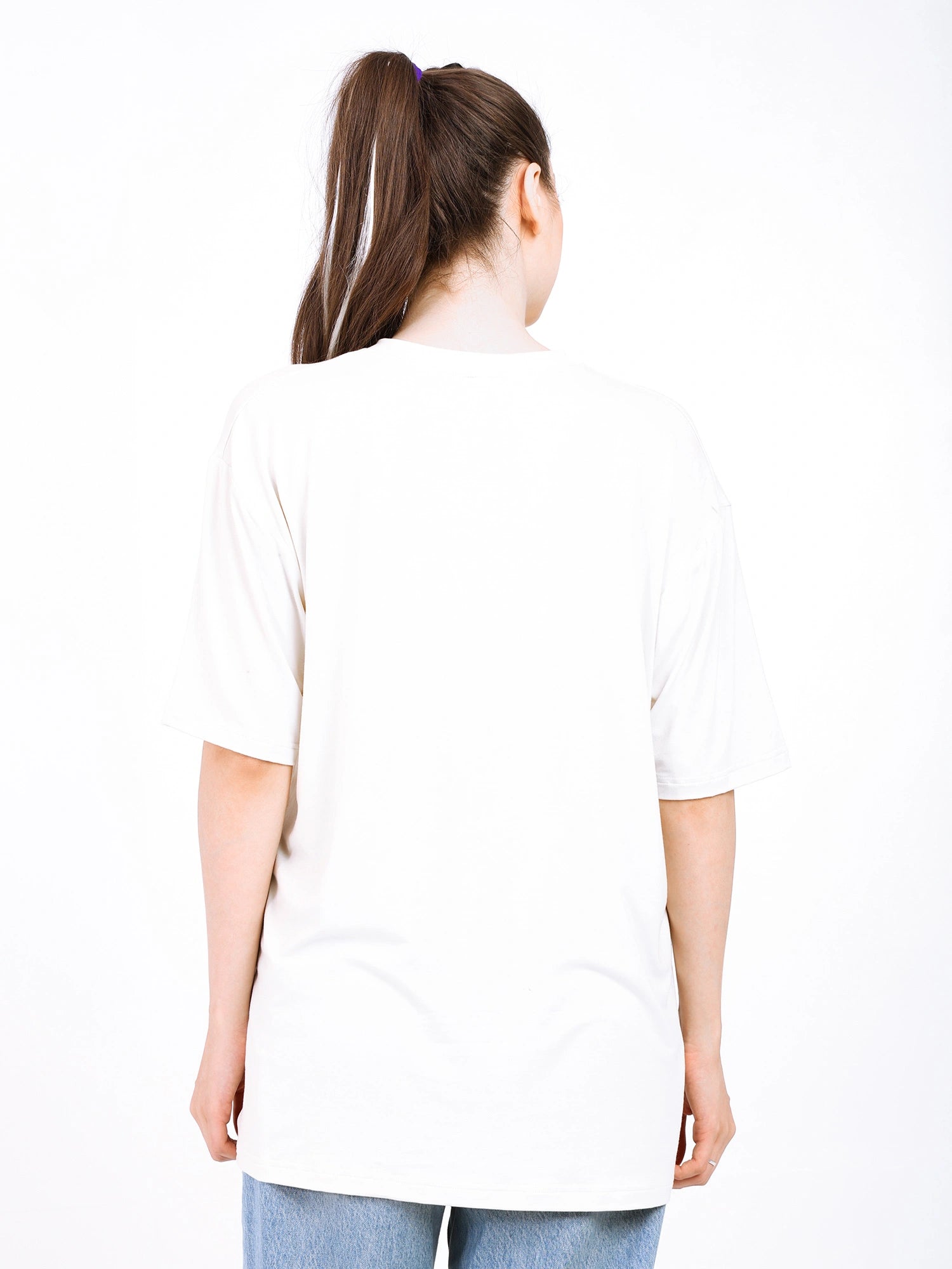 Back view of a woman wearing an oversized bamboo t-shirt, showcasing its loose fit and soft fabric.