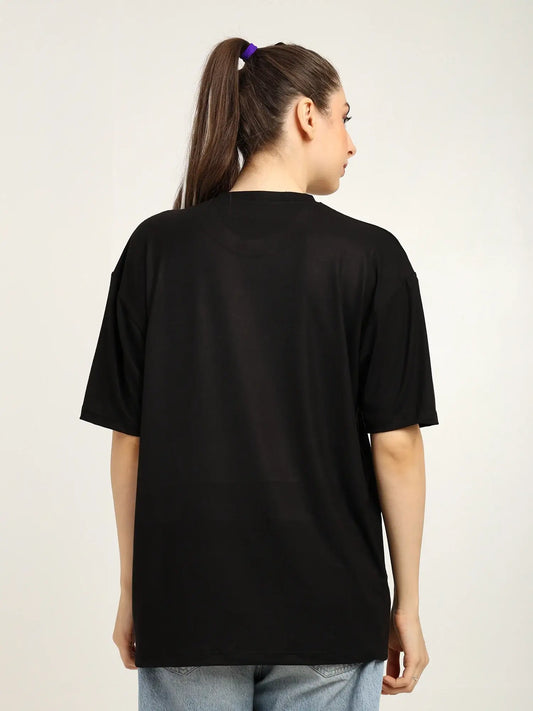 Person wearing a black t-shirt on a plain background