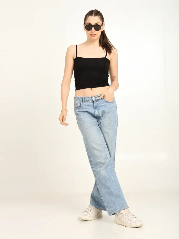 Gen Z woman in black bamboo tube top and light jeans, showcasing effortless style and modern fit.