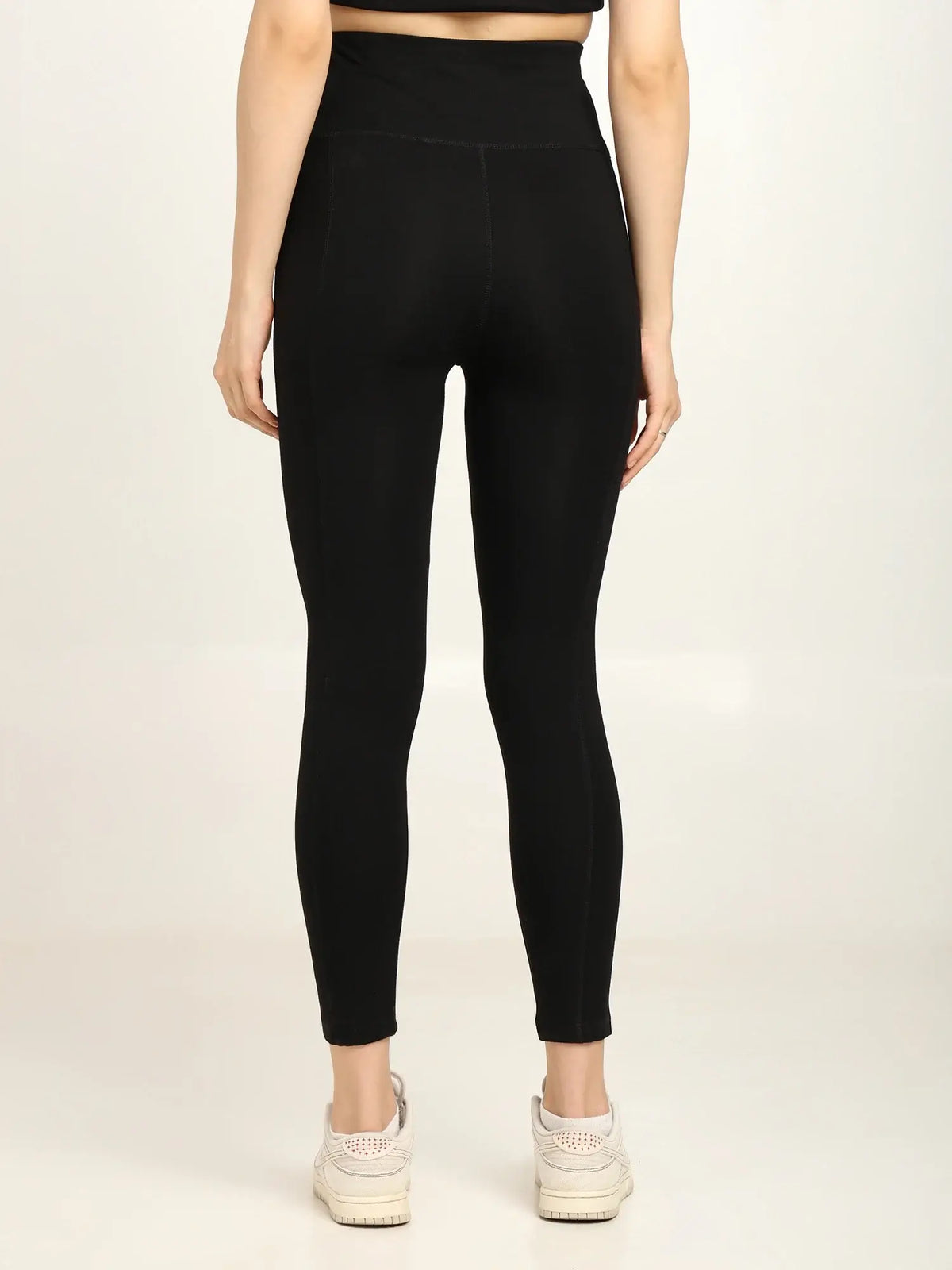 Back view of women's high-waist bamboo yoga pants in black, showcasing soft fabric and sleek design.