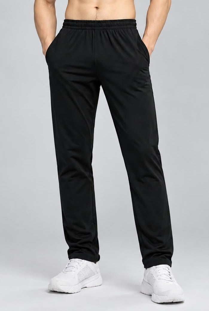 Black bamboo fabric men's track pants on a model, featuring an elastic waistband and side pockets for comfort.