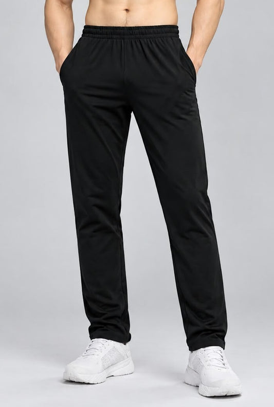 Black bamboo fabric men's track pants on a model, featuring an elastic waistband and side pockets for comfort.