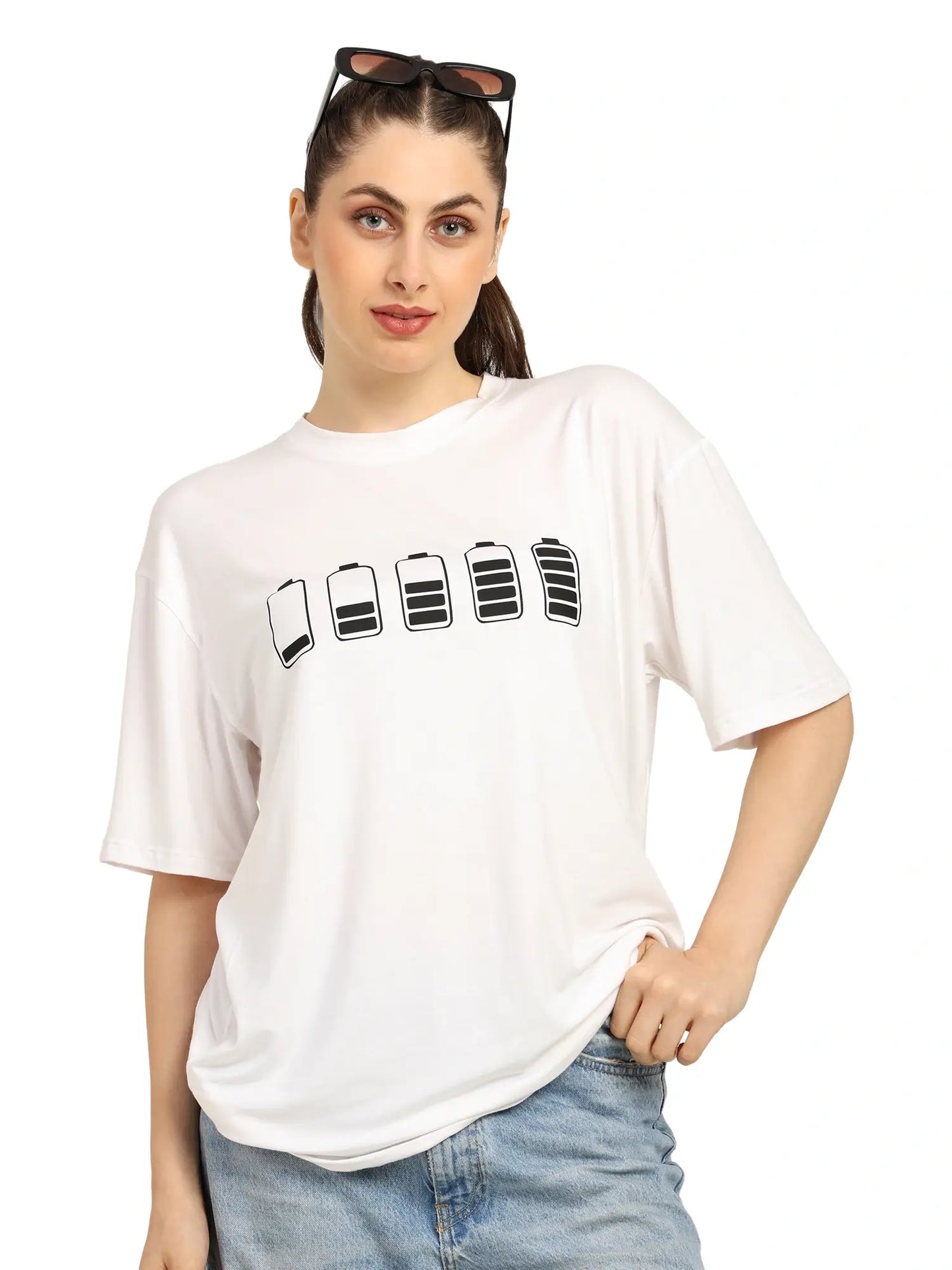 Woman wearing a white oversized bamboo T-shirt with battery graphic, showcasing sustainable streetwear style.