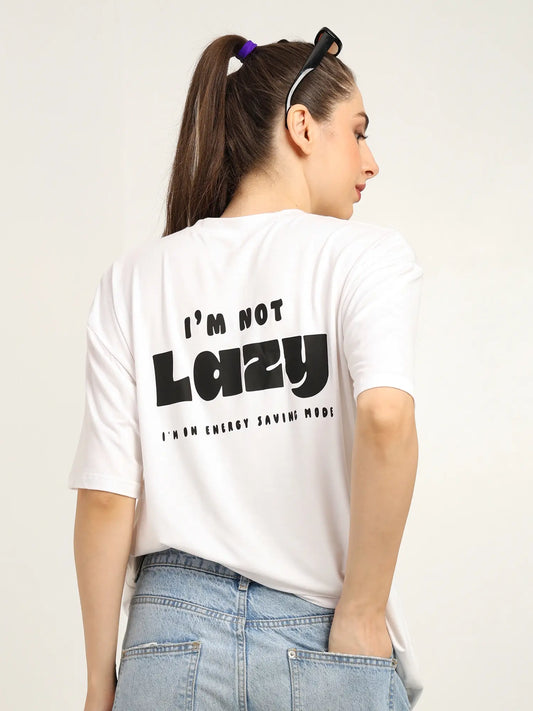Woman wearing white oversized t-shirt with bold text 'I'm Not Lazy' on the back, highlighting casual streetwear style.