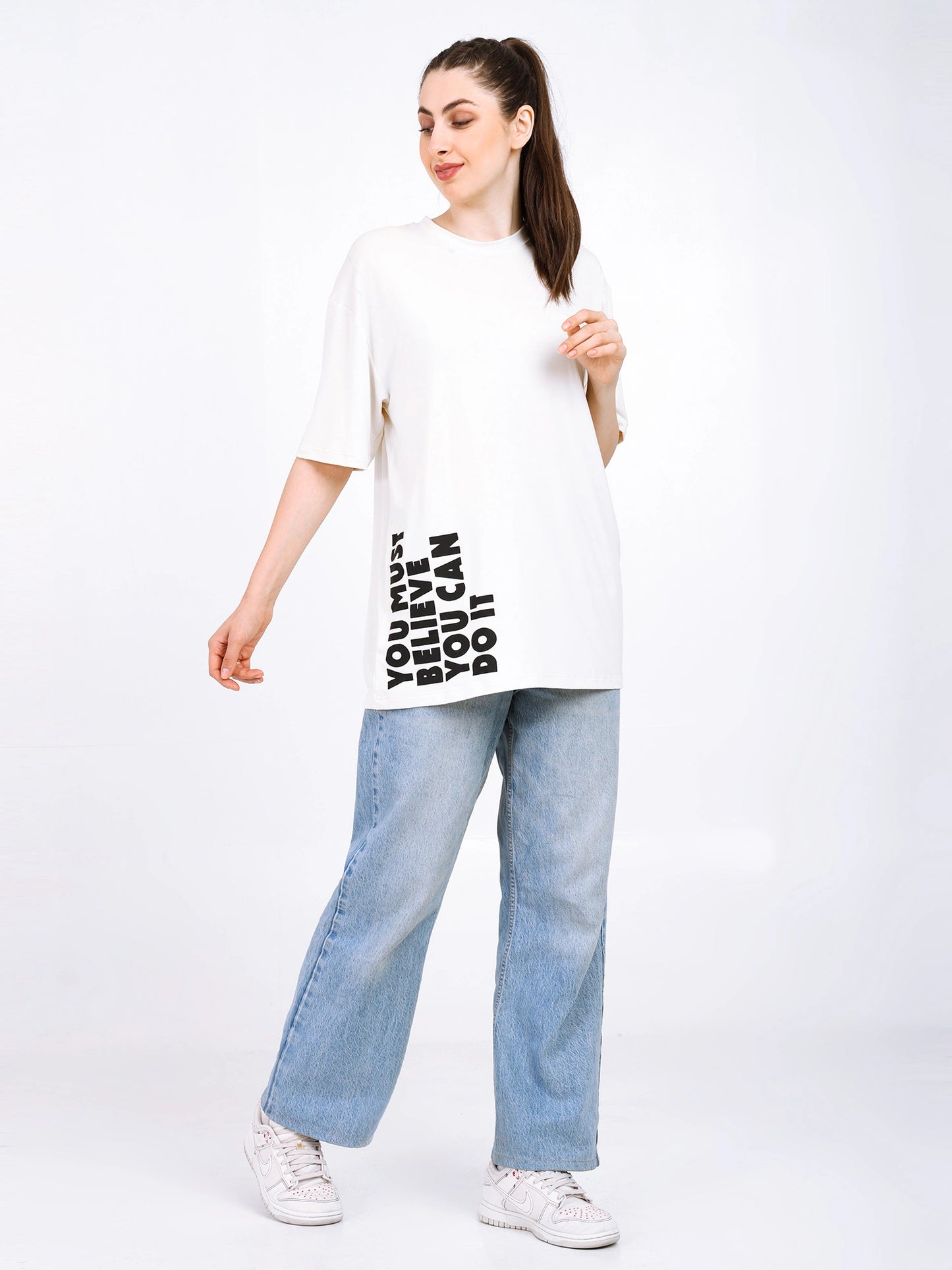 Women oversized bamboo T-shirt in white with graphic print, styled with light denim and sneakers for casual streetwear.