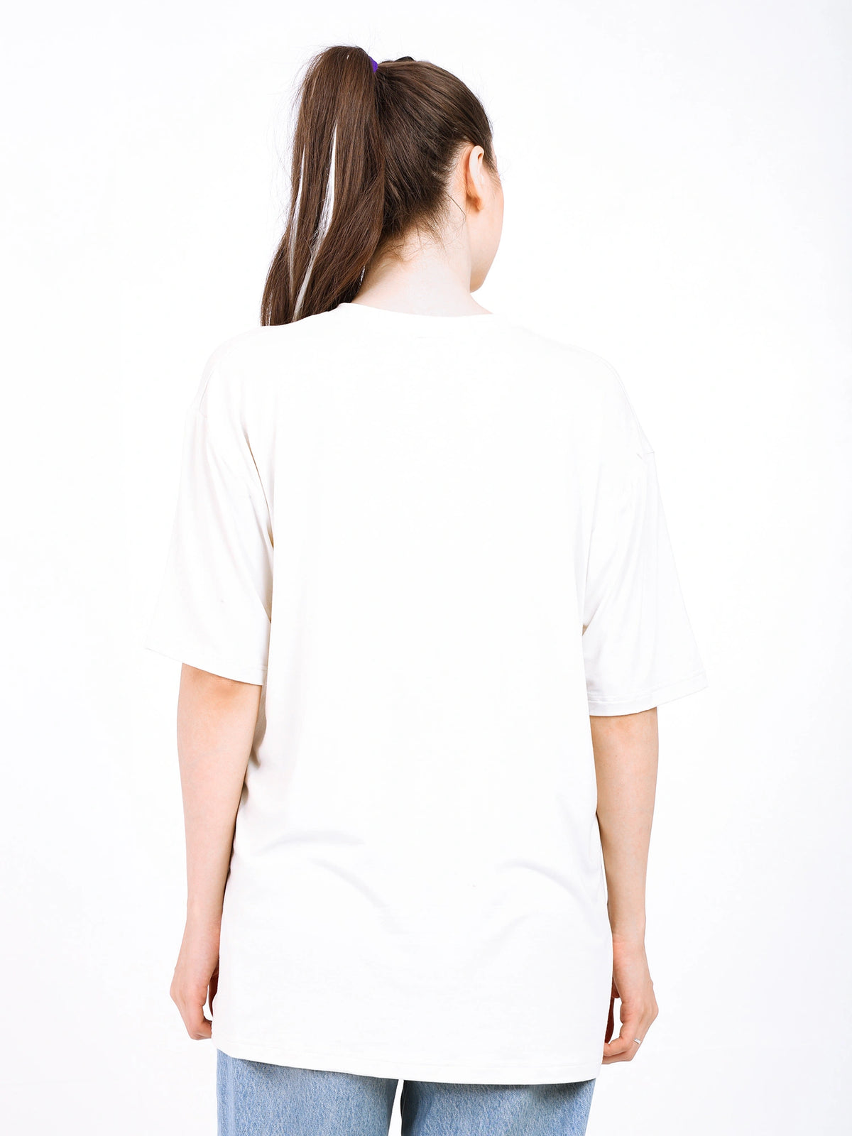 Back view of a woman wearing an oversized bamboo t-shirt, showcasing its loose fit and soft fabric.