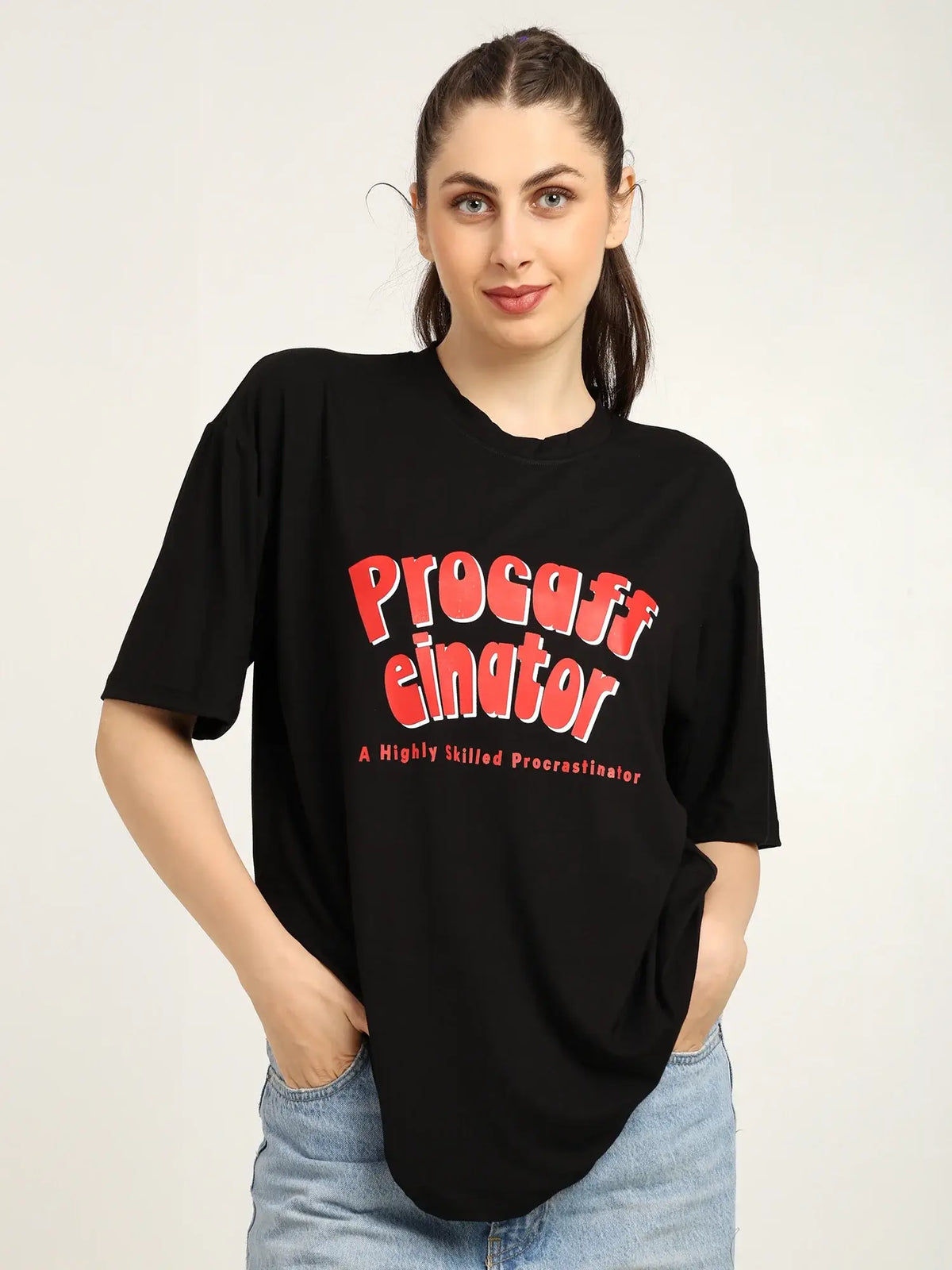 Woman wearing a black t-shirt with red text on a plain background