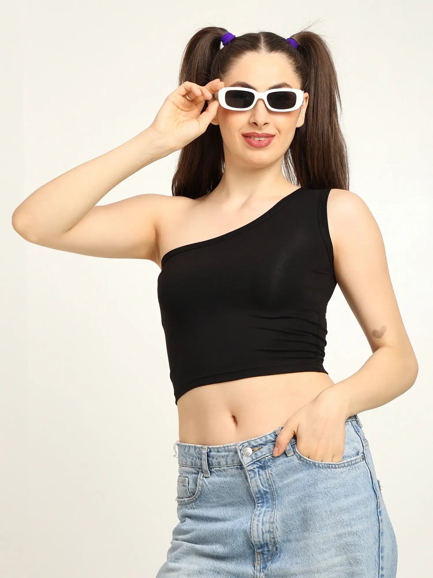 Gen Z bamboo one shoulder top in black, styled with sunglasses and casual jeans.