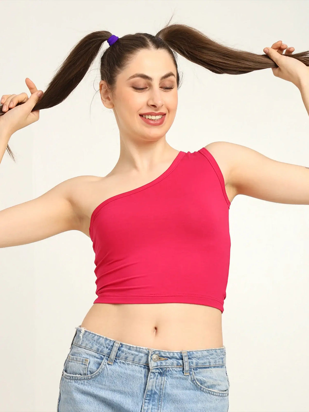 Model wearing a pink one shoulder bamboo top, showcasing its soft, breathable fit and stylish design.