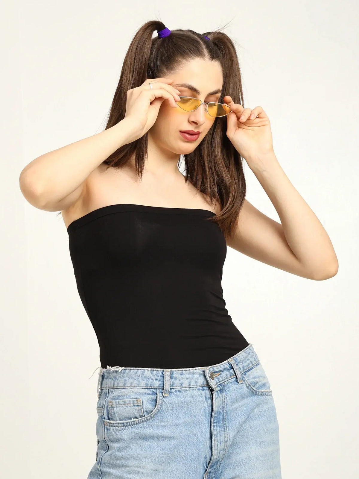 Gen Z woman wearing a black bamboo tube top with sunglasses, showcasing a stylish and modern look.