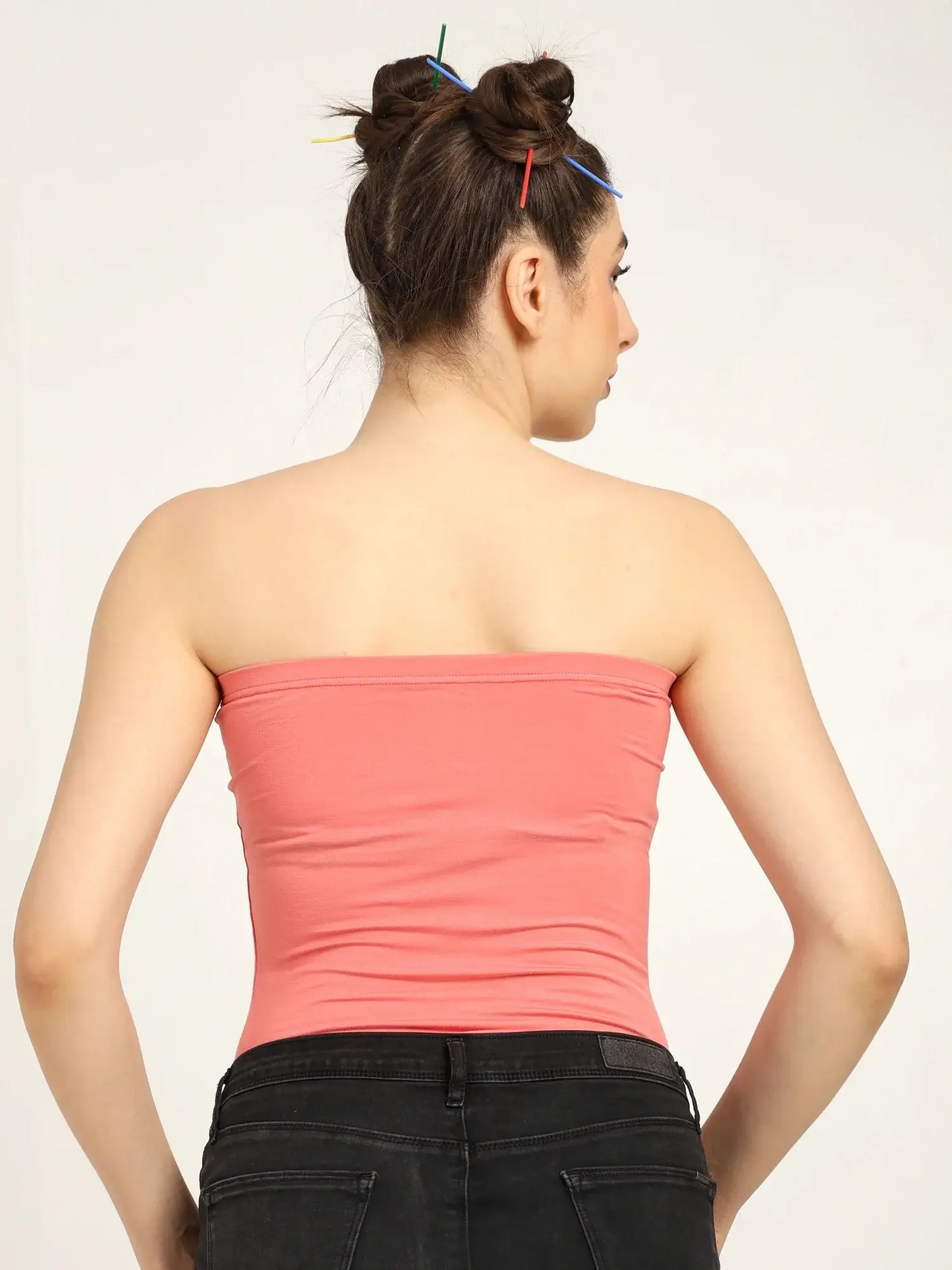 Back view of a woman wearing a soft pink bamboo tube top, showcasing its breathable fit and modern style.