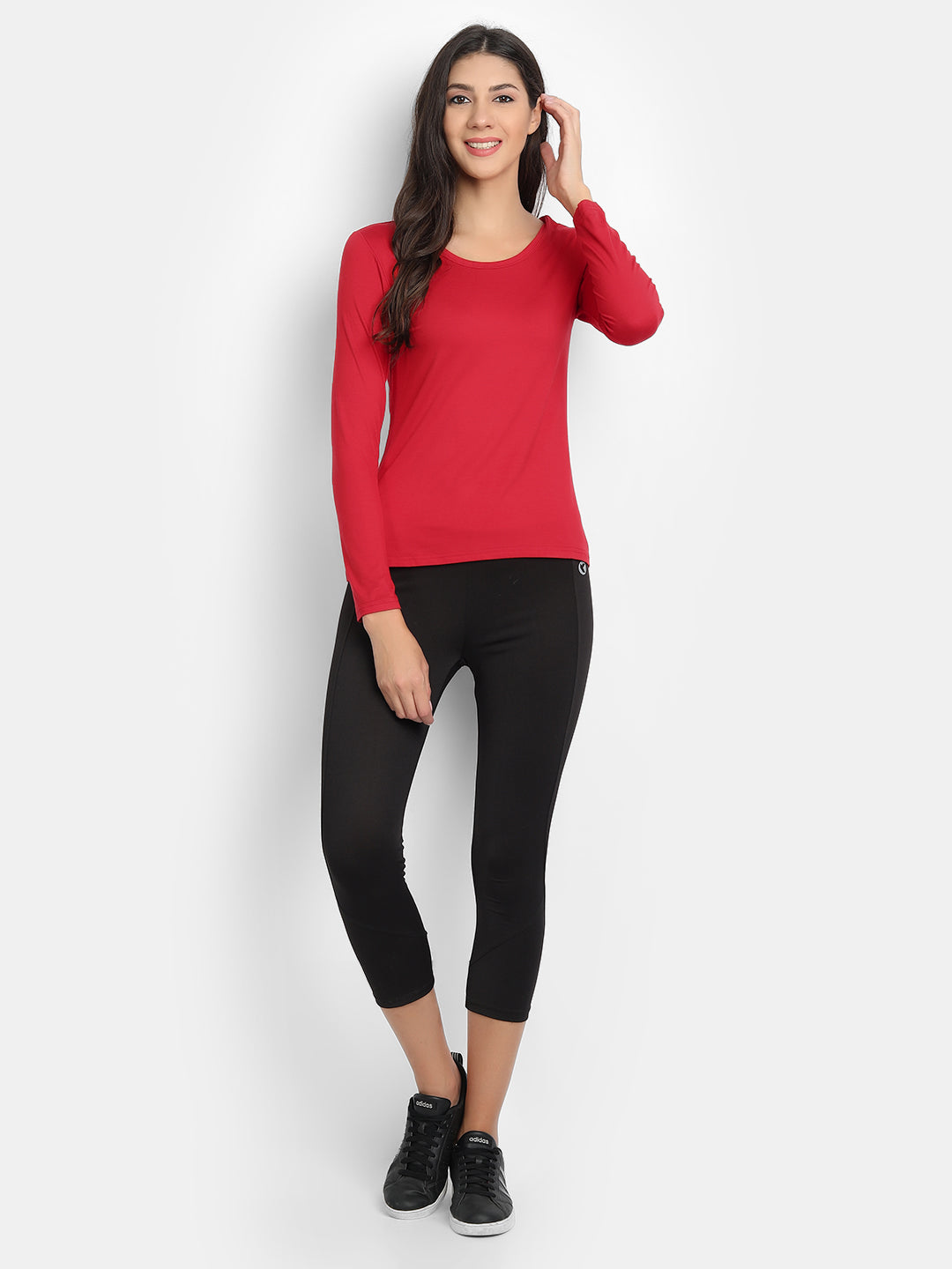Model wearing a red men's bamboo fabric full sleeves t-shirt paired with black leggings and sneakers.